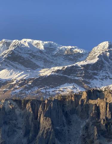 Snow-capped mountains under a clear blue sky.