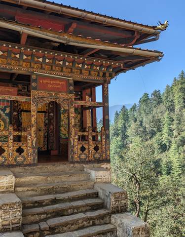 Detailed view of traditional Bhutanese architecture amidst trees.