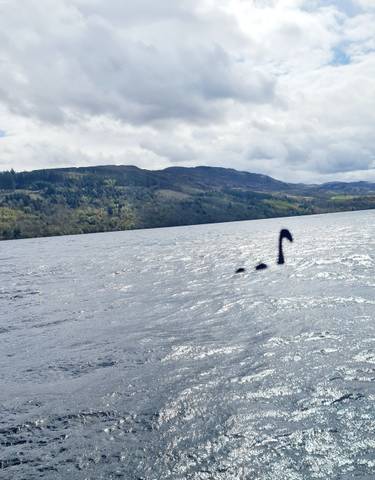 Large body of water with hills in the background and a mysterious object in the lake.