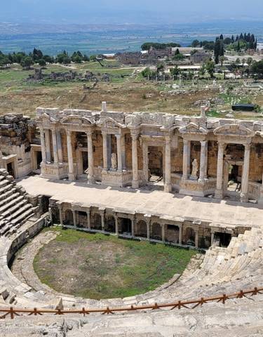 Ancient amphitheater ruins with detailed architecture.