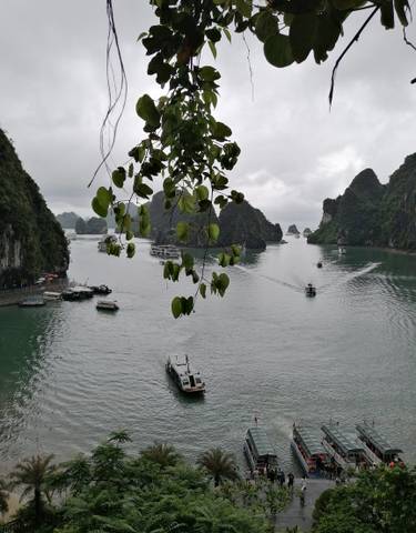 Scenic view of a bay with limestone islets and boats.