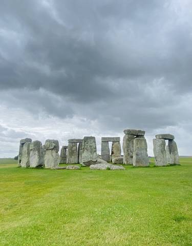 Iconic Stonehenge monument against a cloudy sky.