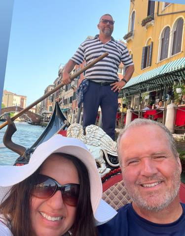Couple enjoying a gondola ride in Venice.
