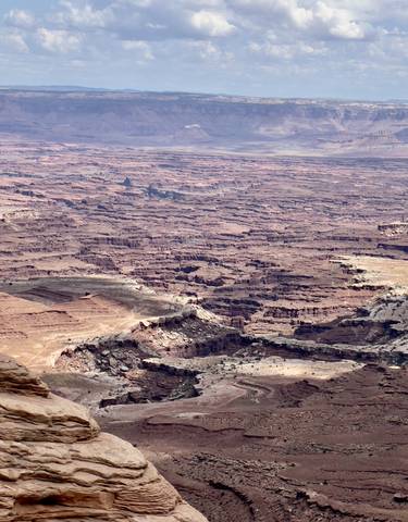 Expansive view of a canyon landscape with layers of rock formations.