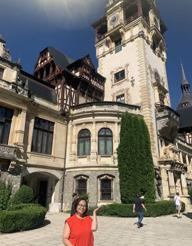View of Peles Castle with detailed architecture and greenery.