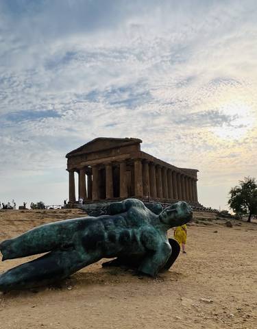 Ancient temple ruins with sculpture of a reclining figure.