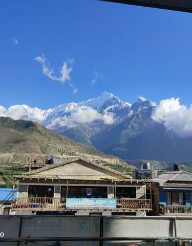 Mountains and village with clear blue sky.