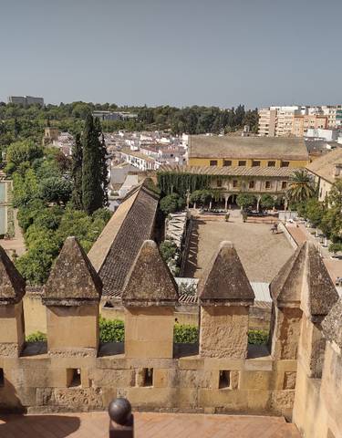 Scenic view of a city with historical architecture and gardens.