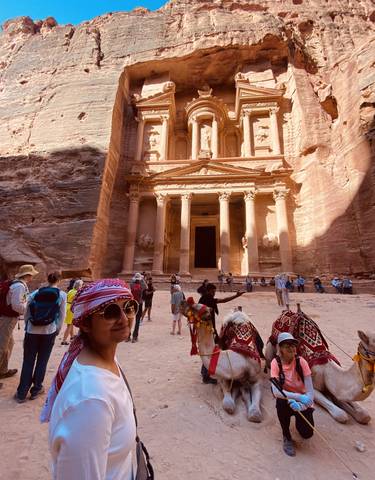 Tourists exploring the ancient structure in Petra.
