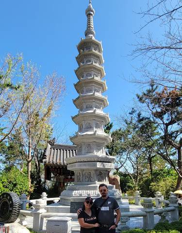 A tall, intricately decorated pagoda with trees around it.