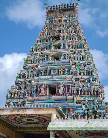 Colorful temple tower adorned with intricate statues.