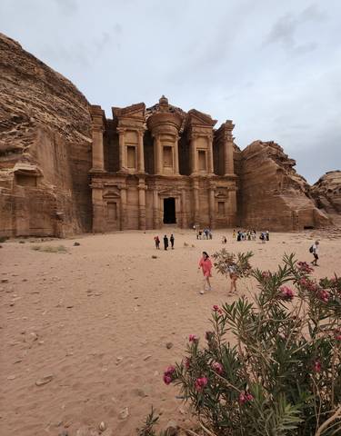 Tourists in front of the facade of an ancient structure. 