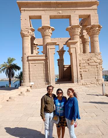A group standing before an ancient temple.