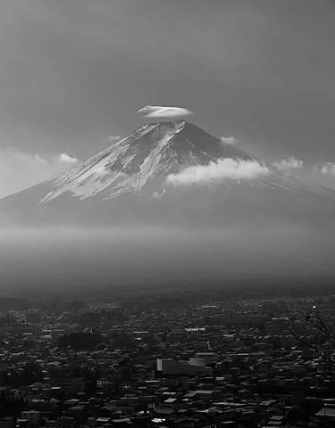 Mount Fuji with clouds at the peak.