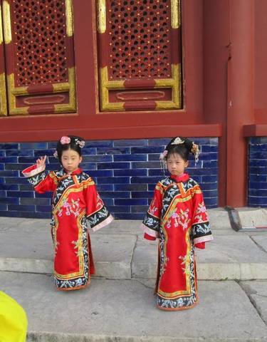 Children dressed in traditional attire posing.