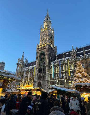 Iconic clock tower in Munich with Christmas decorations and snow.
