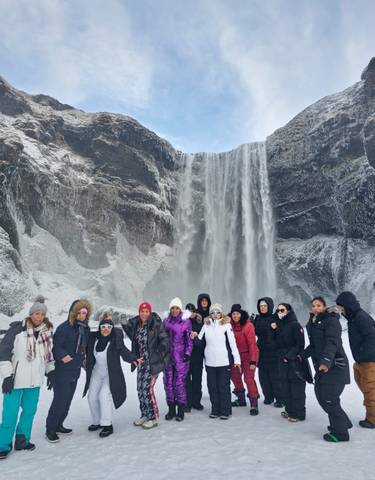 Group in front of a large waterfall.