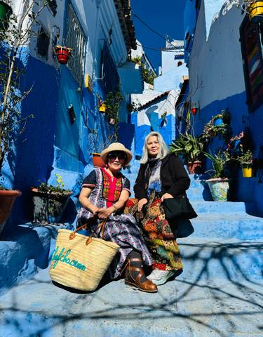 Two women in a blue-painted street.