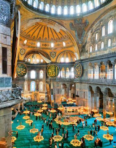 Interior of a large historical mosque with people