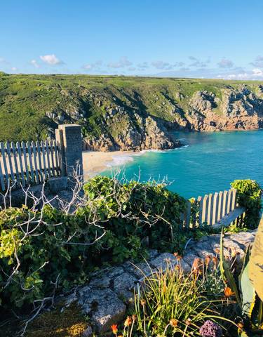 Cliffside view of a beach with turquoise water.