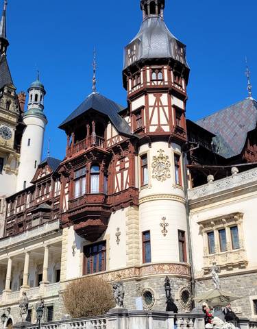 Ornate castle with multiple towers and decorative facades against a clear sky.