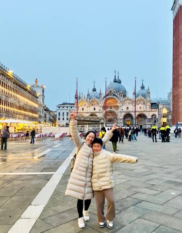 Tourists posing with St. Mark's Basilica in the background