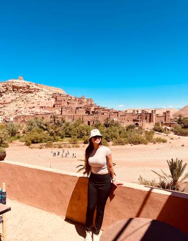 Person posing with Ait Benhaddou in the background.
