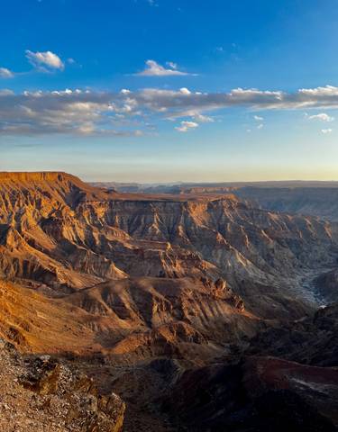 The grand canyon landscape with dramatic rock formations at sunset.