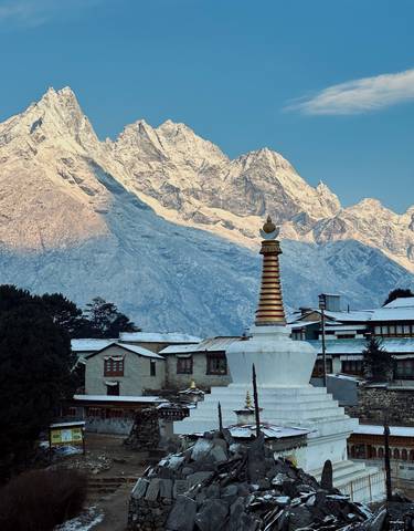 Buddhist stupa with a snow-covered mountain backdrop.