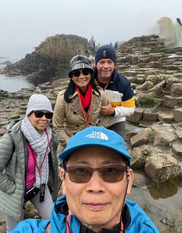 Group of people posing on a rocky landscape.