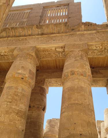Ancient columns with hieroglyphics in Egyptian temple.