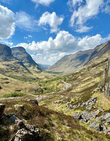 Expansive view of a scenic valley with mountains.