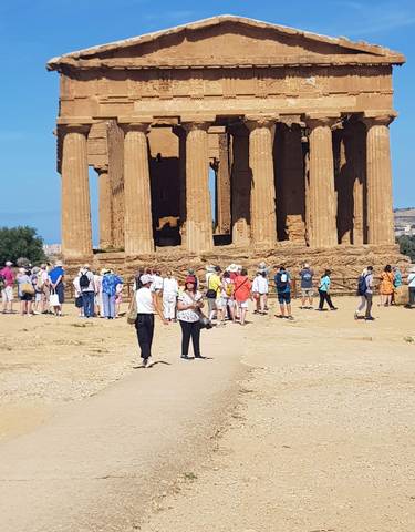 Tourists exploring ancient ruins in Agrigento.