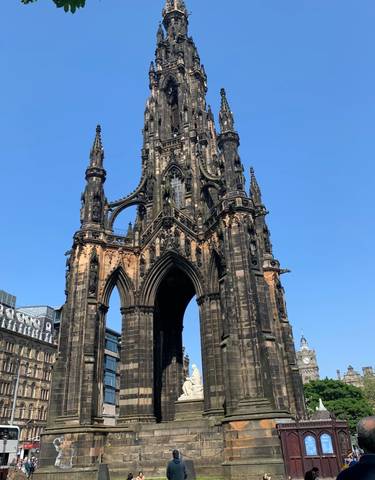 Scott Monument in Edinburgh under a clear blue sky.