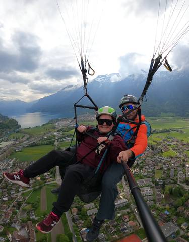 Paragliding over a scenic landscape with mountains.