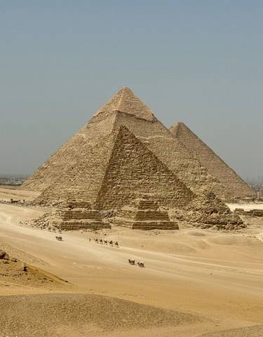Great Pyramid of Giza with two smaller pyramids in the desert.