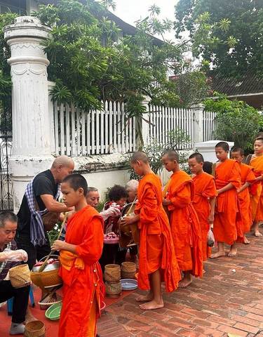Procession of monks receiving offerings.