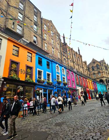 Colorful shops in a lively urban street with people.