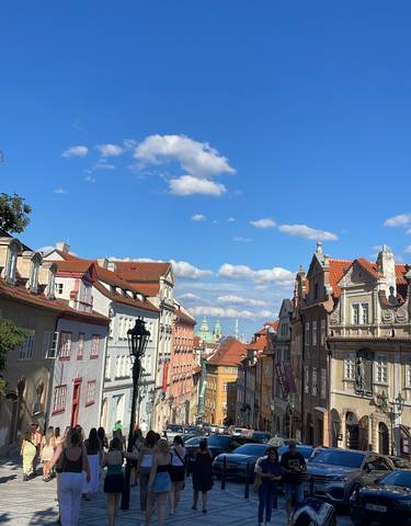 View of colorful buildings under a blue sky with clouds.
