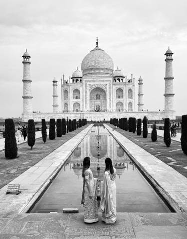 Taj Mahal with reflection and visitors in foreground.