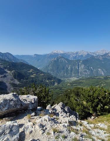 Expansive mountain range with lush valleys.