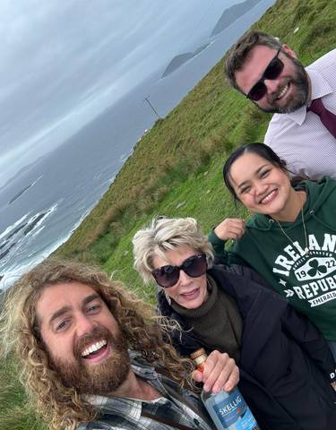 Group with ocean background, smiling and posing.