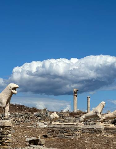 Ancient stone lions on Delos island with a blue sky.