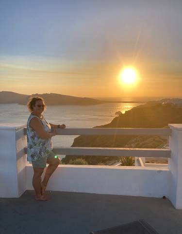 A person enjoying sunset views over the Greek islands.
