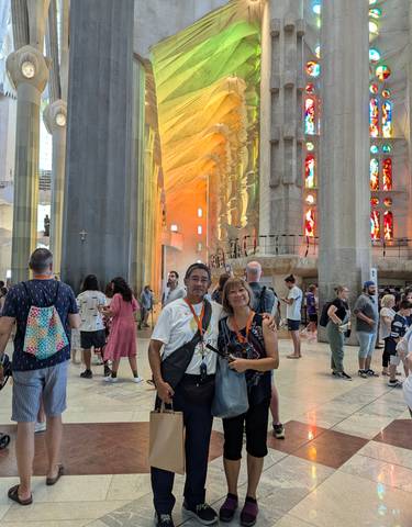 People inside a large cathedral with colorful stained glass windows