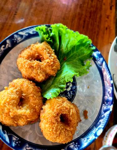 Fried food dish with a garnish of lettuce.