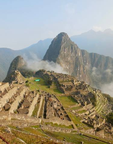 Machu Picchu archaeological site with mountains and clouds