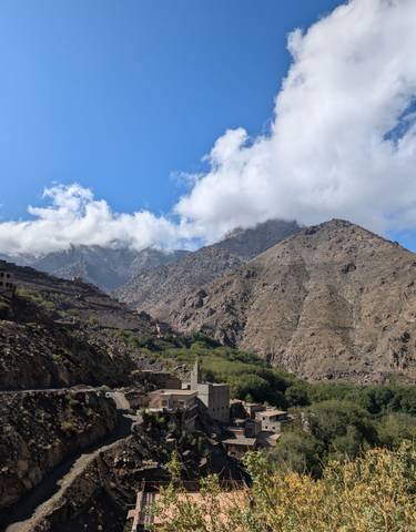 Mountain landscape with clear blue sky and clouds.