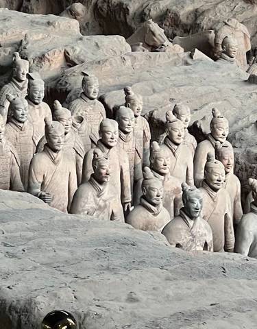 Terracotta Warriors in a large excavation pit.