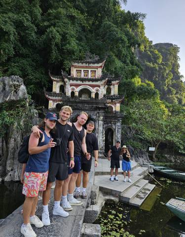 Group of people in front of a traditional Asian temple.
